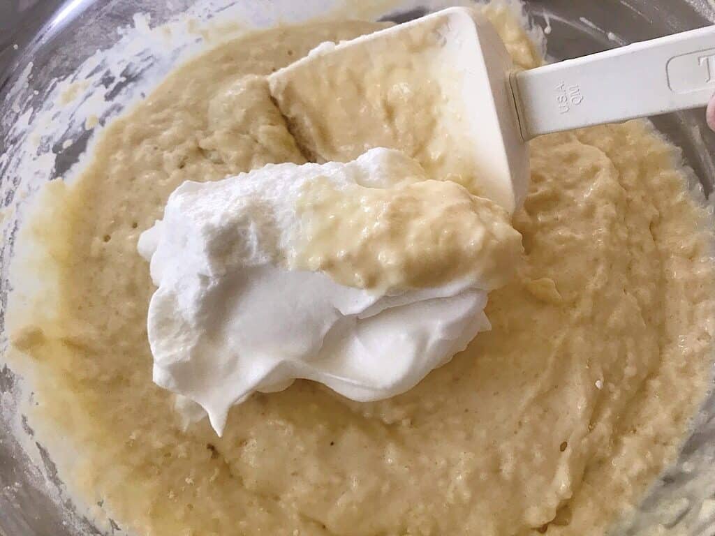 Egg whites being mixed into crispy waffle batter.