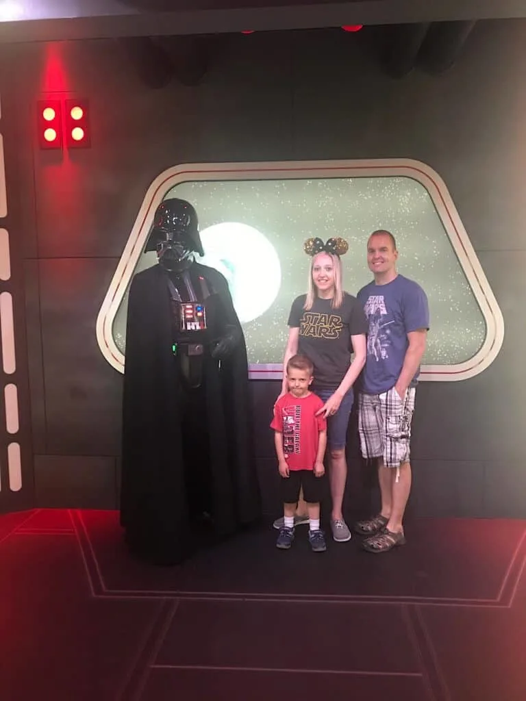 Darth Vader with a Mom, Dad, and little boy at Disneyland.