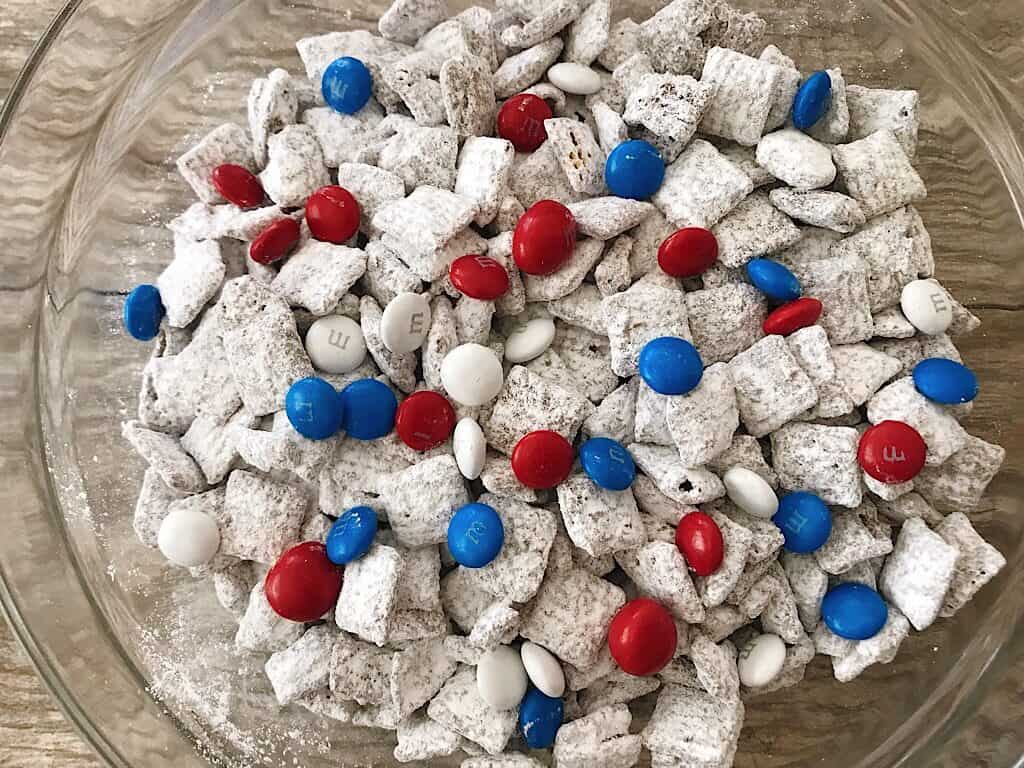 A bowl of Muddy Buddies with Red, White, and Blue M&M’s for the 4th of July.