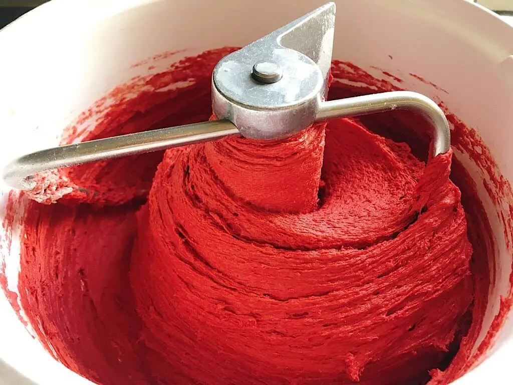 Red Velvet cinnamon roll dough in a stand mixer