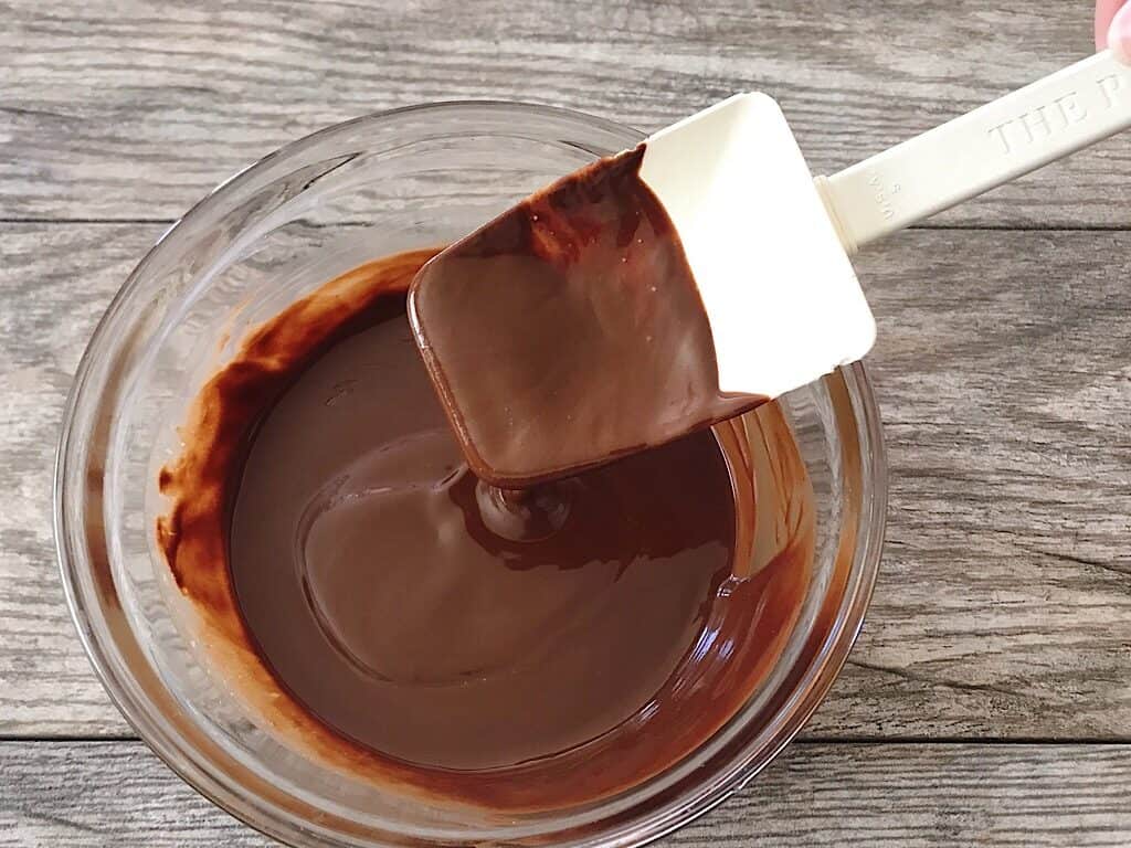 A spoon of melted chocolate.