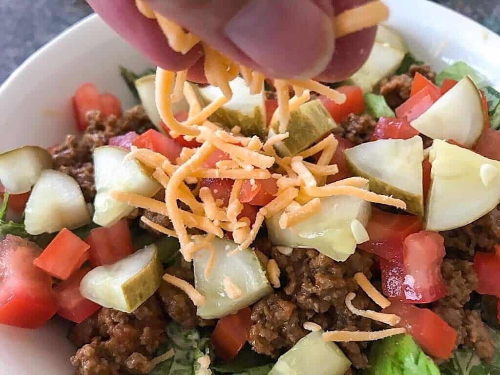 Cheese sprinkles on a Big Mac salad