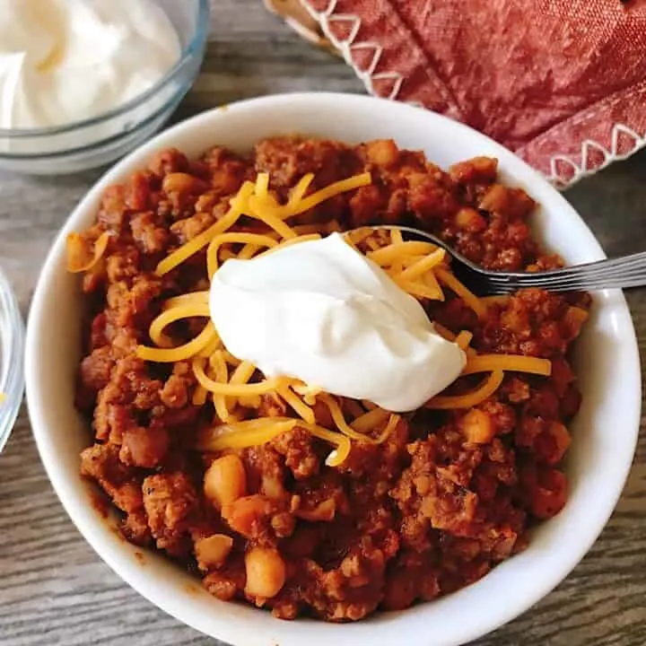 A bowl of buffalo chicken chili with cheese and sour cream