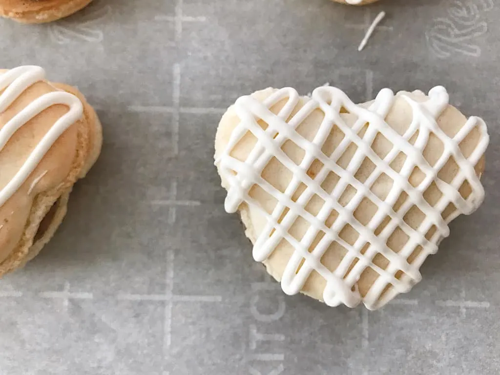 White chocolate drizzled on a macaron