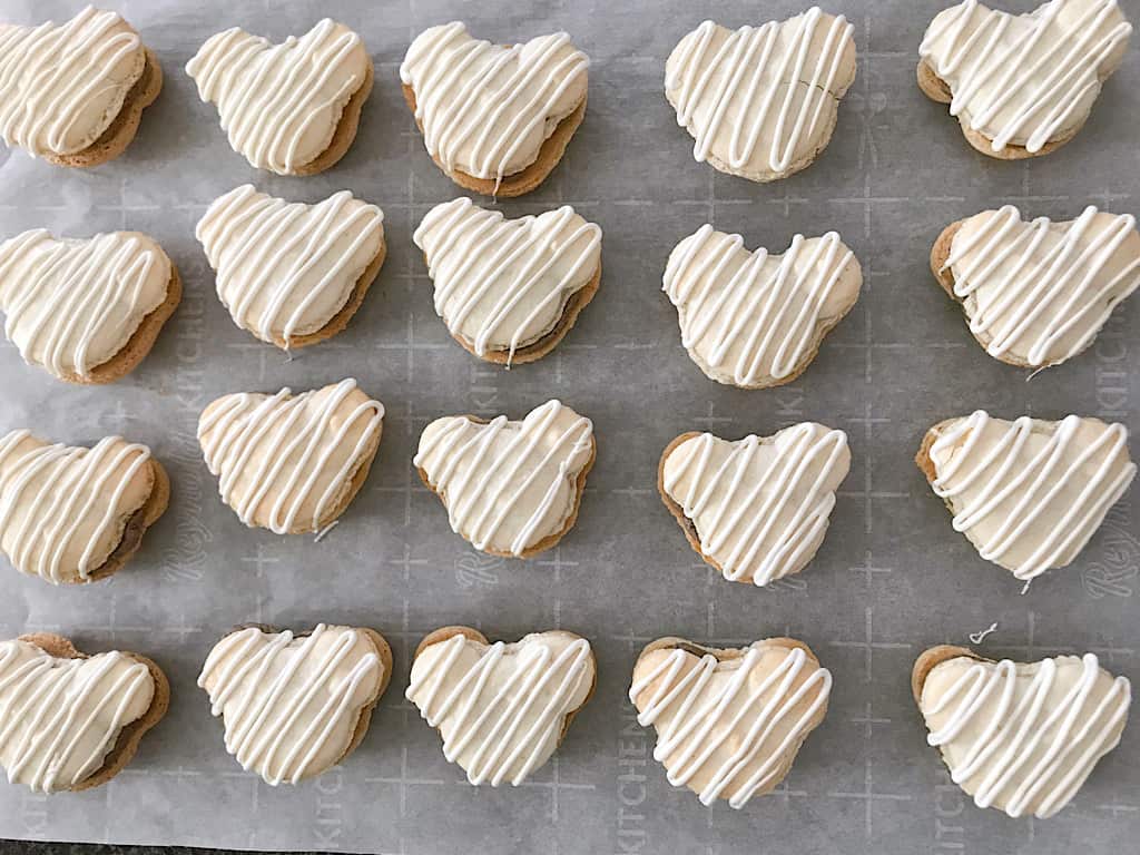 White chocolate drizzled on Mickey Macarons