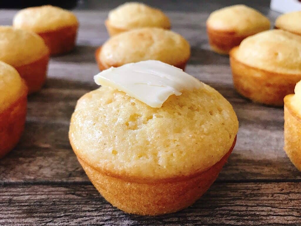 Cornbread Muffins topped with butter.