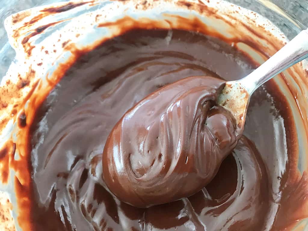 A spoonful of chocolate ganache for Graveyard Cupcakes
