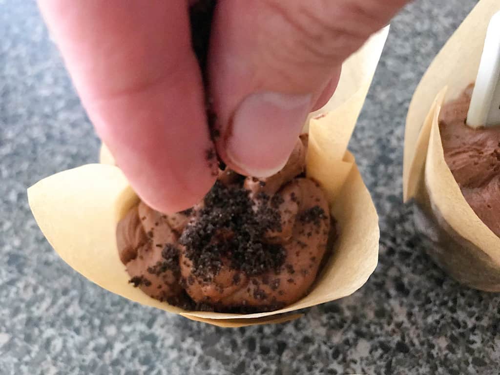 OREO crumbs sprinkled on graveyard cupcakes.