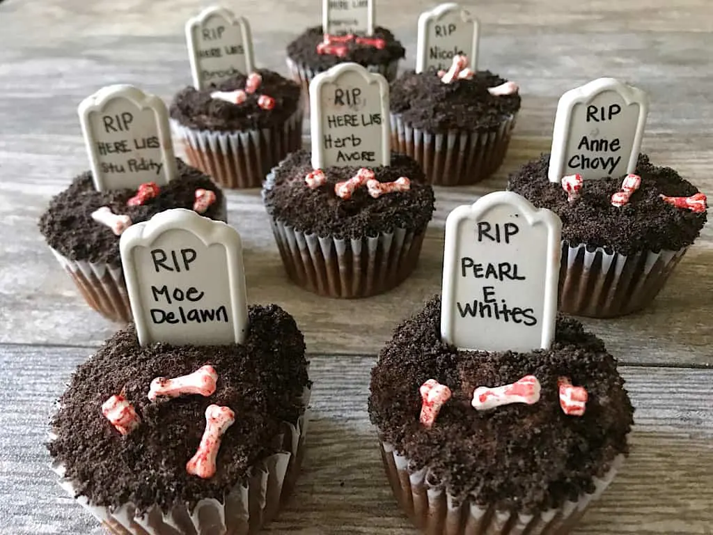 Graveyard cupcakes with candy bones and candy tombstones with funny names