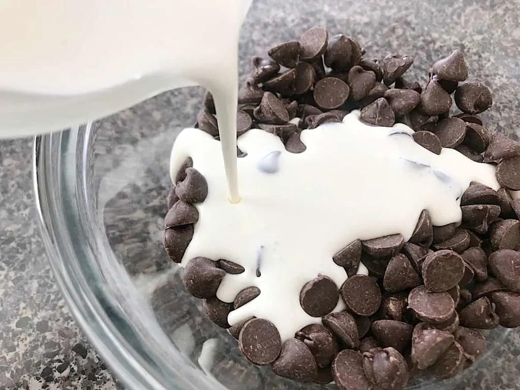 Heavy cream poured on chocolate chips for ganache