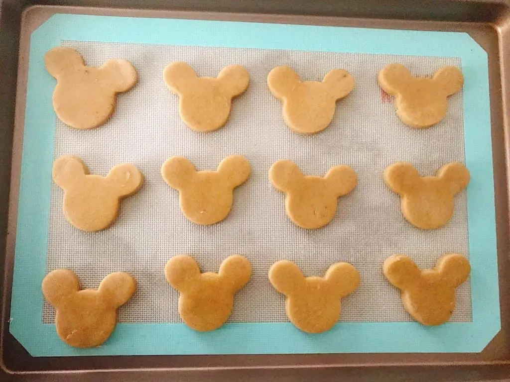 Mickey Mouse shaped Gingerbread Sugar Cookie dough on a baking sheet