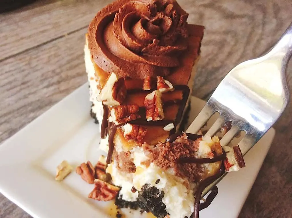 A bite of a copycat Cheesecake Factory Turtle Pecan Cheesecake