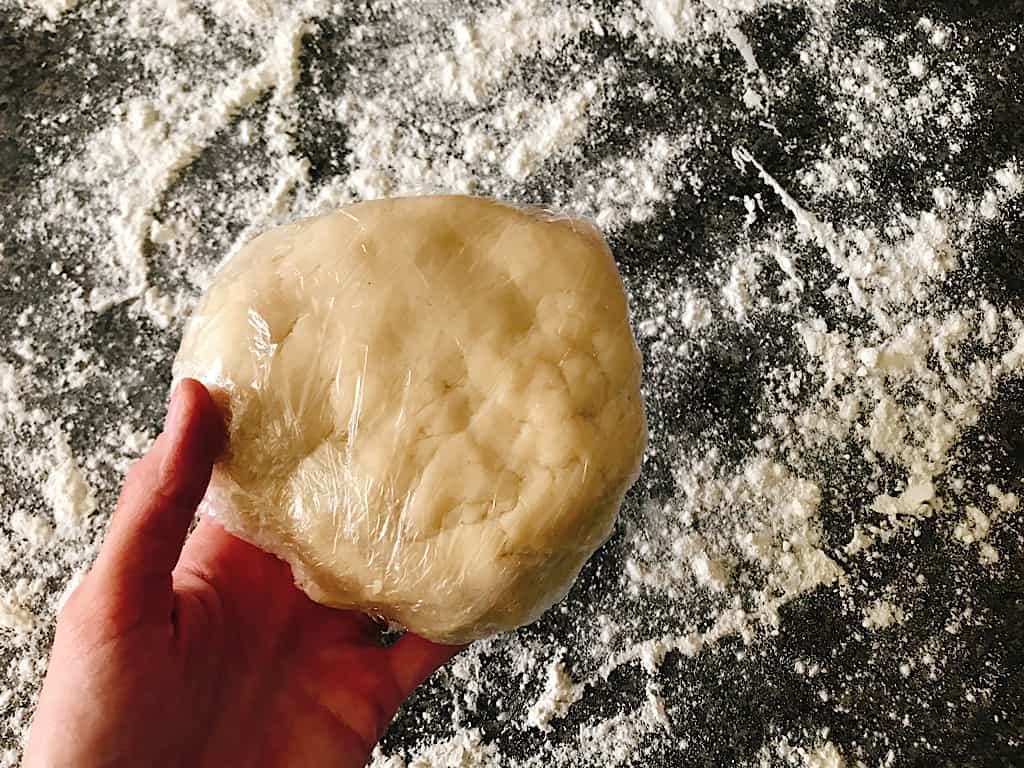 All butter pie crust dough wrapped in plastic wrap