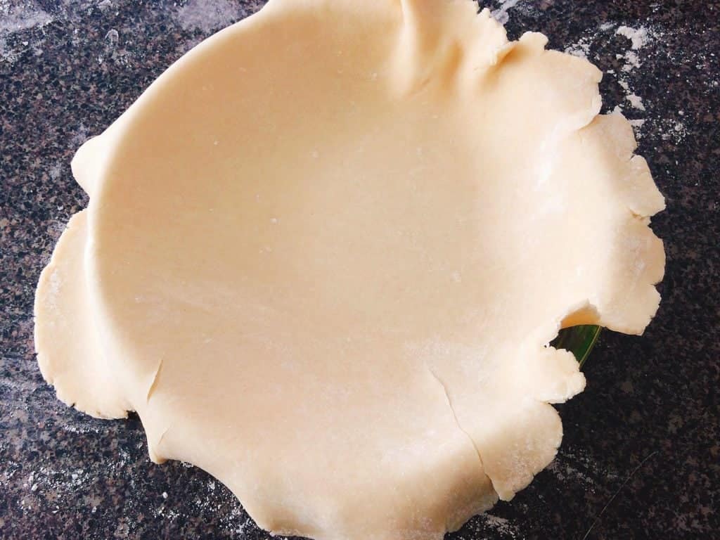 A pie crust in a pie dish.
