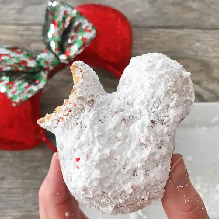 A Candy Cane Mickey Beignet and Christmas Minnie Mouse Ears