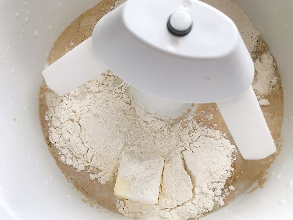 Flour, milk, butter, eggs, salt, and sugar in a stand mixer to make Lion House Rolls.