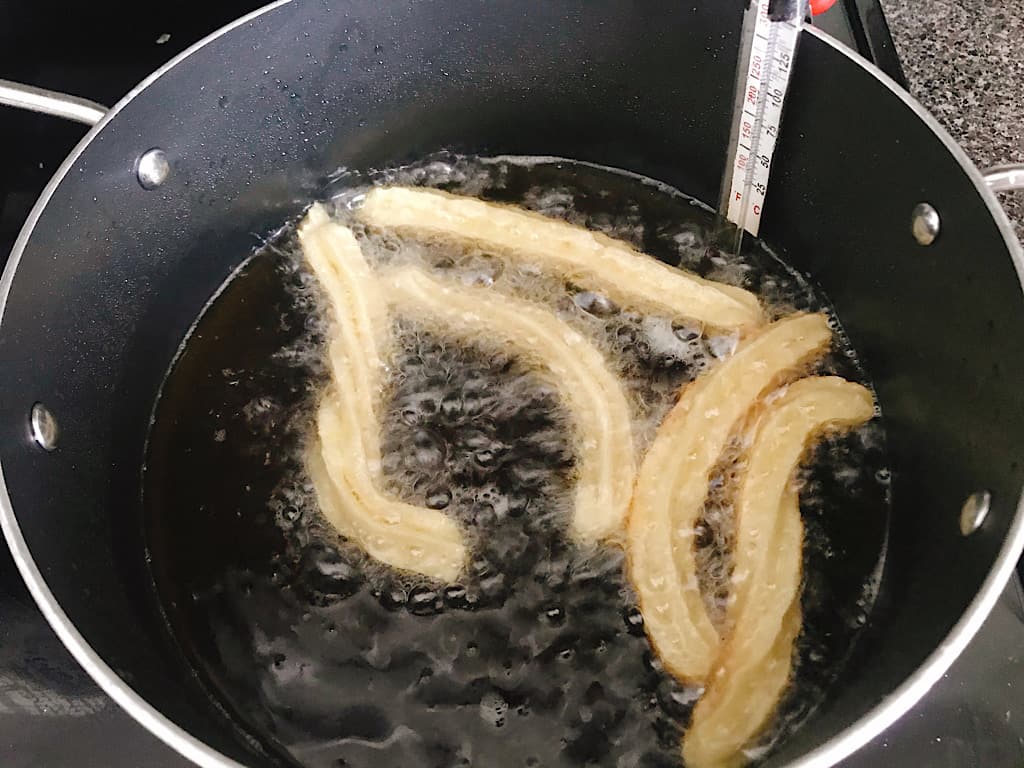 Christmas Disneyland Churros frying in oil.