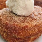 A homemade cronut topped with vanilla ice cream.