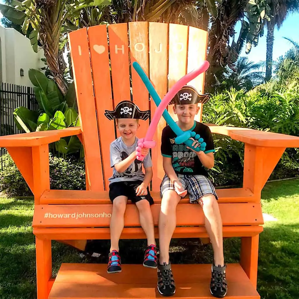 Two kids in pirate gear on the chair at Howard Johnson Anaheim