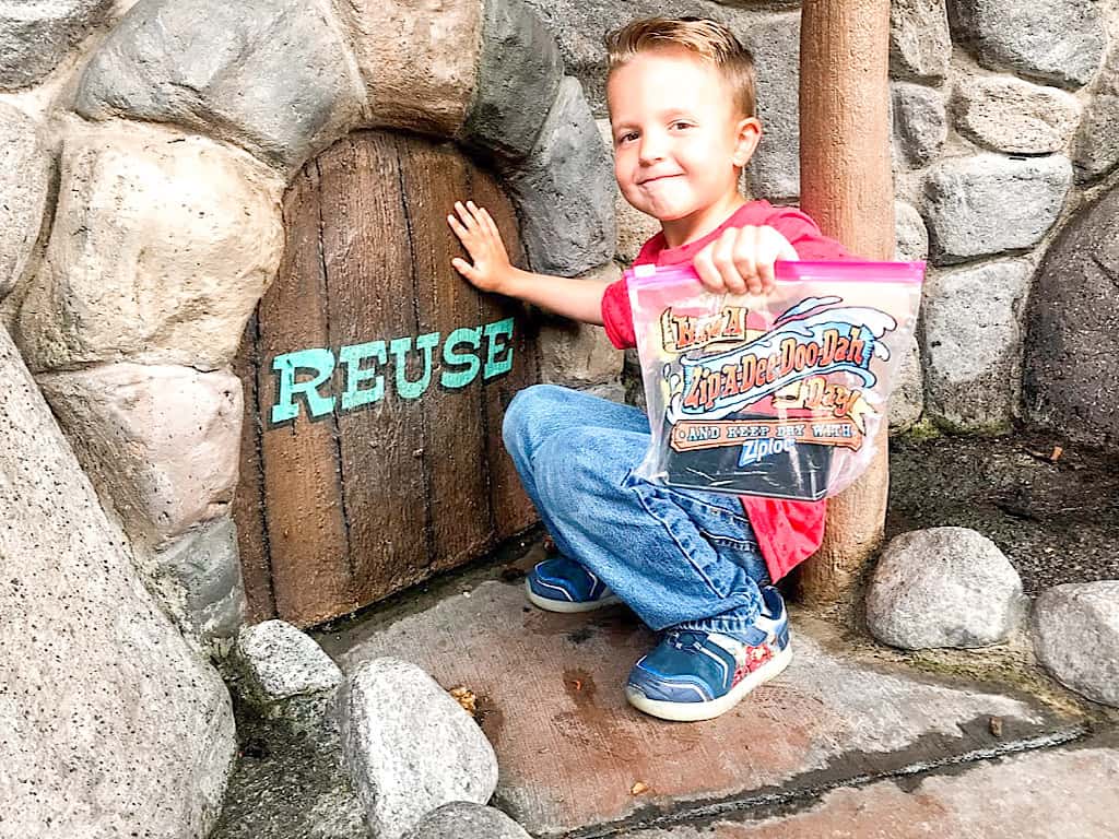 A boy with a ziplock back at Disneyland