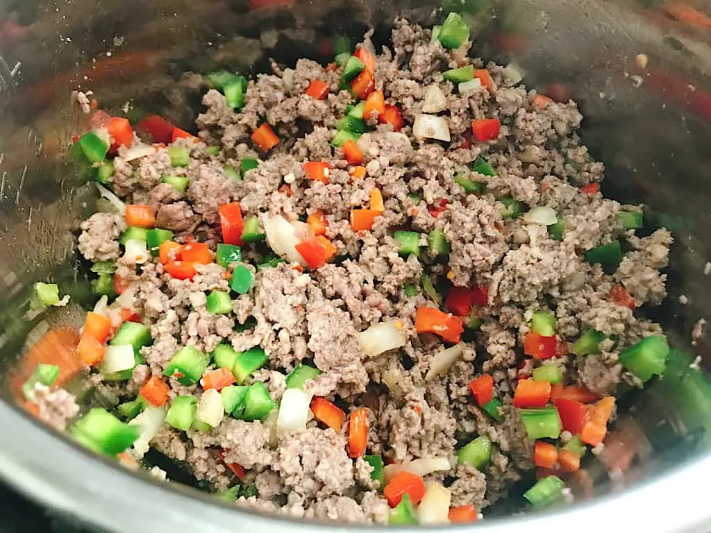 Sausage, ground beef, onions, and peppers in an Instant Pot