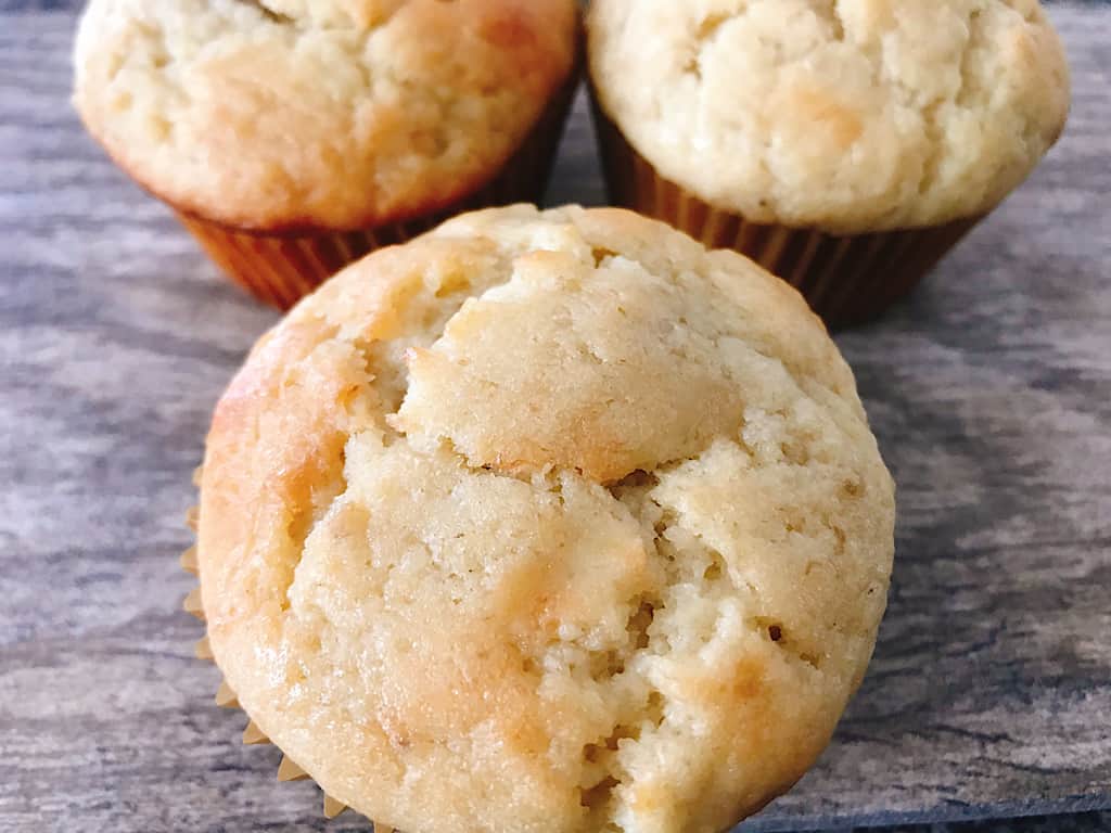 Three banana cream muffins with cinnamon cream cheese filling