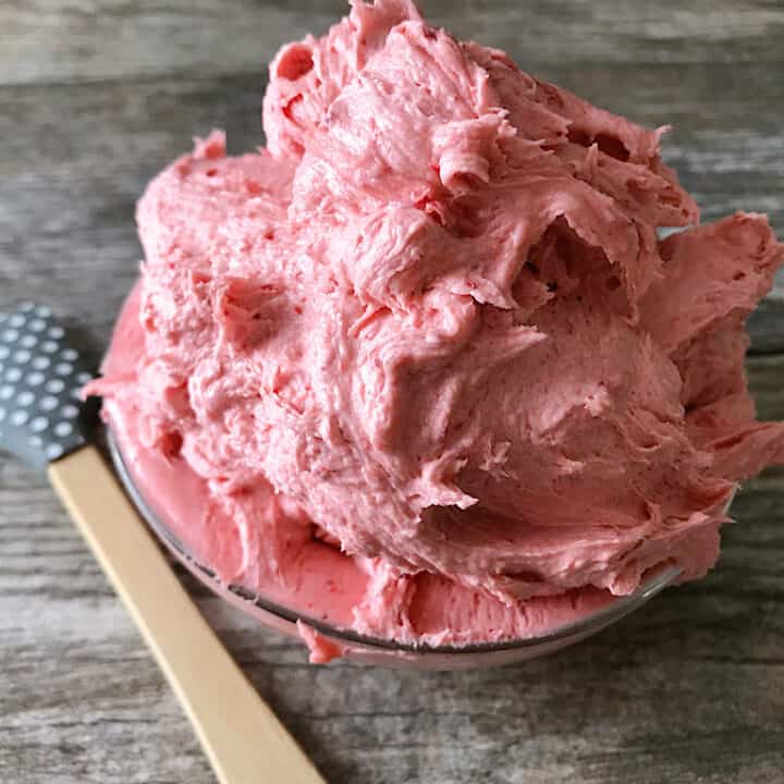 A bowl of strawberry buttercream frosting