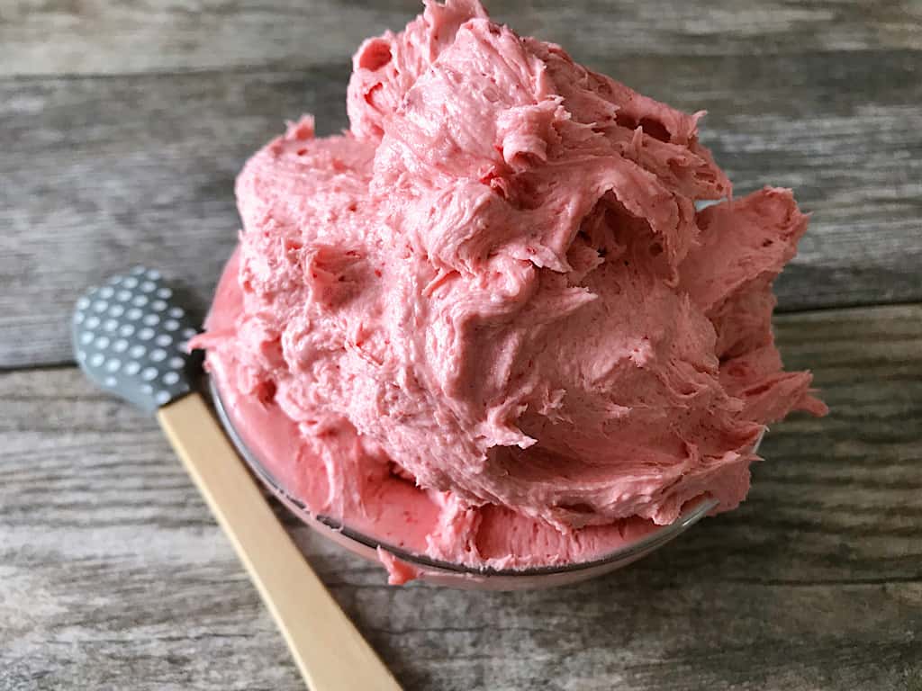 A bowl of strawberry buttercream frosting