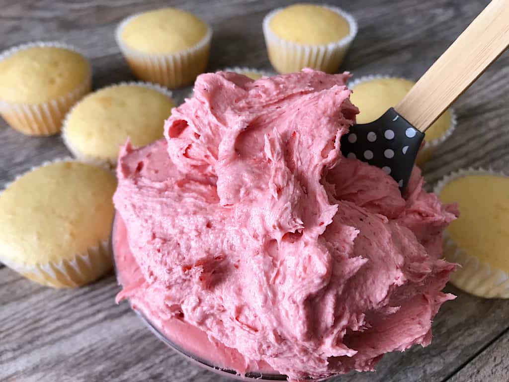 Strawberry frosting and vanilla cupcakes