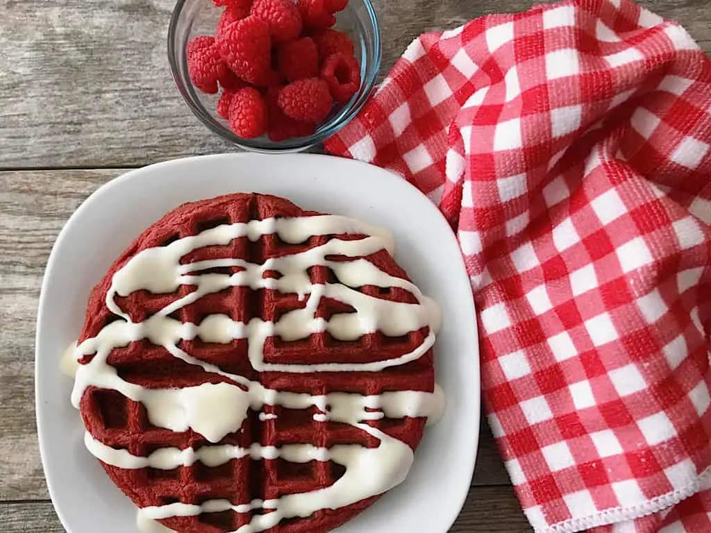 Red Velvet Cake Mix waffle with raspberries and cream cheese glaze