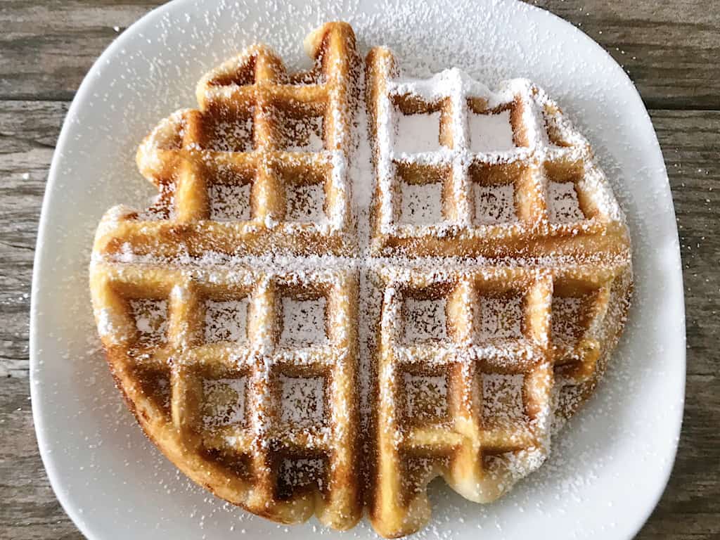 A funnel cake waffle with powdered sugar