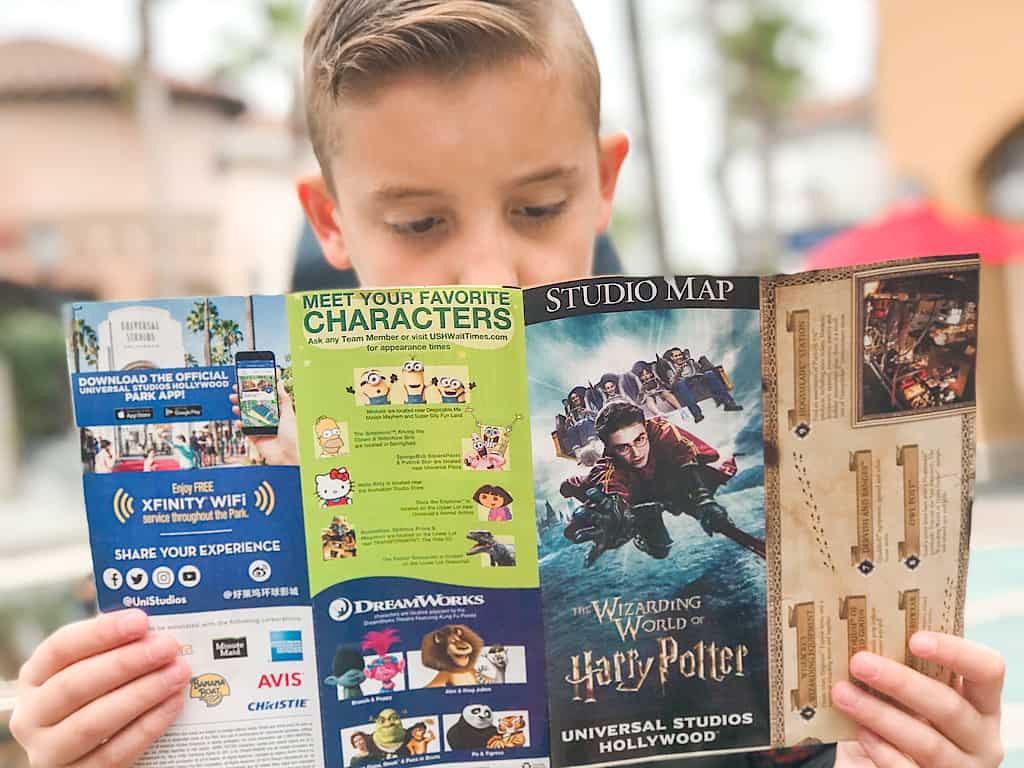 A boy reading a map of Universal Studios Hollywood