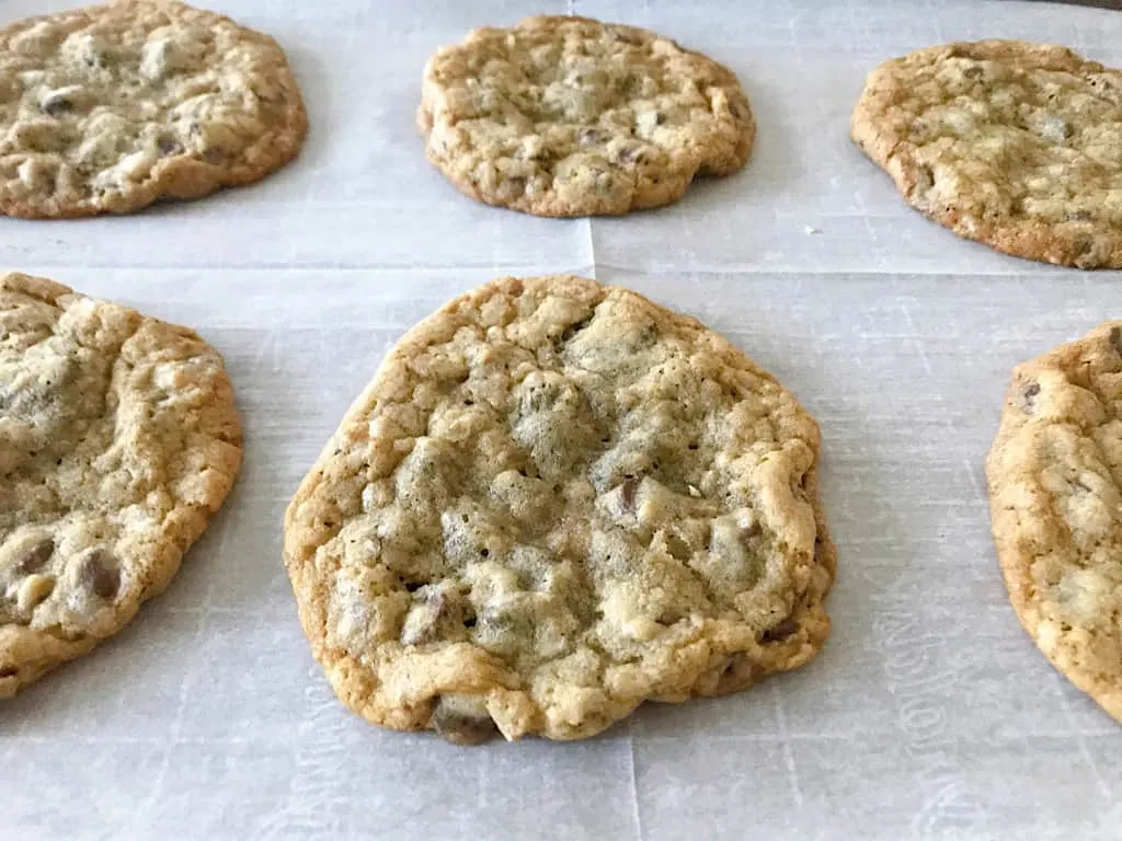 Baked chocolate chip cookies on parchment paper