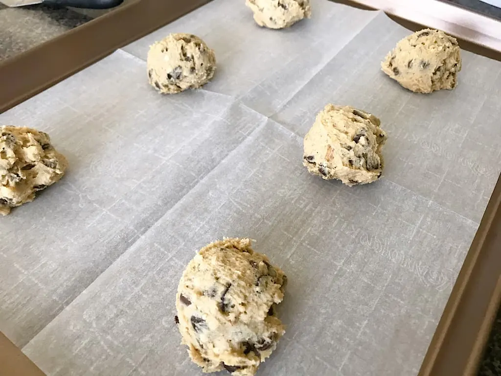 Chocolate chip cookie dough on a baking sheet