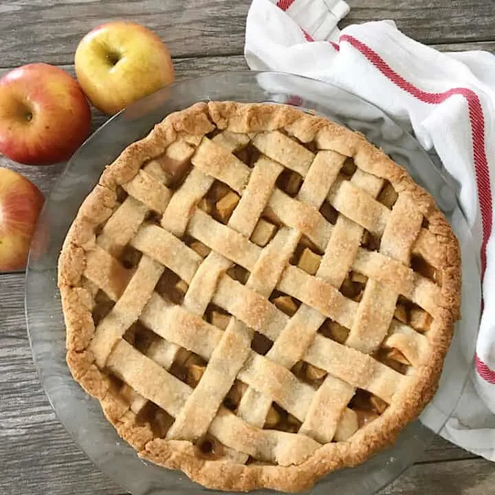 Caramel Apple Pie with 3 apples and a dish towel.