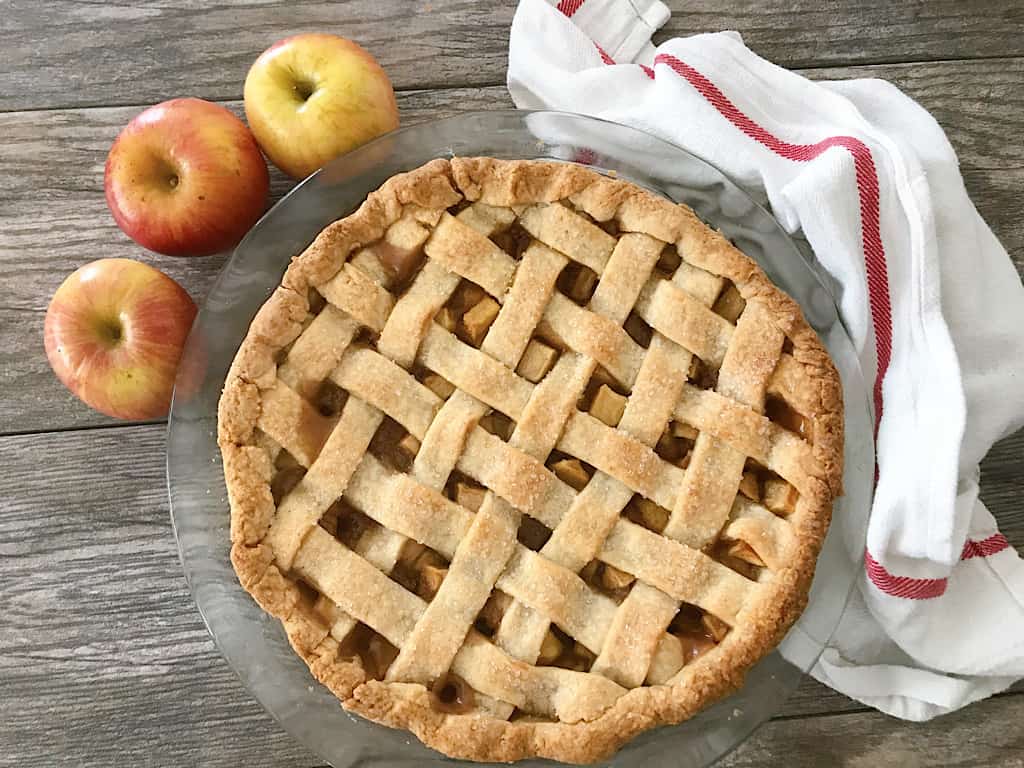 Caramel Apple Pie with 3 apples and a dish towel.