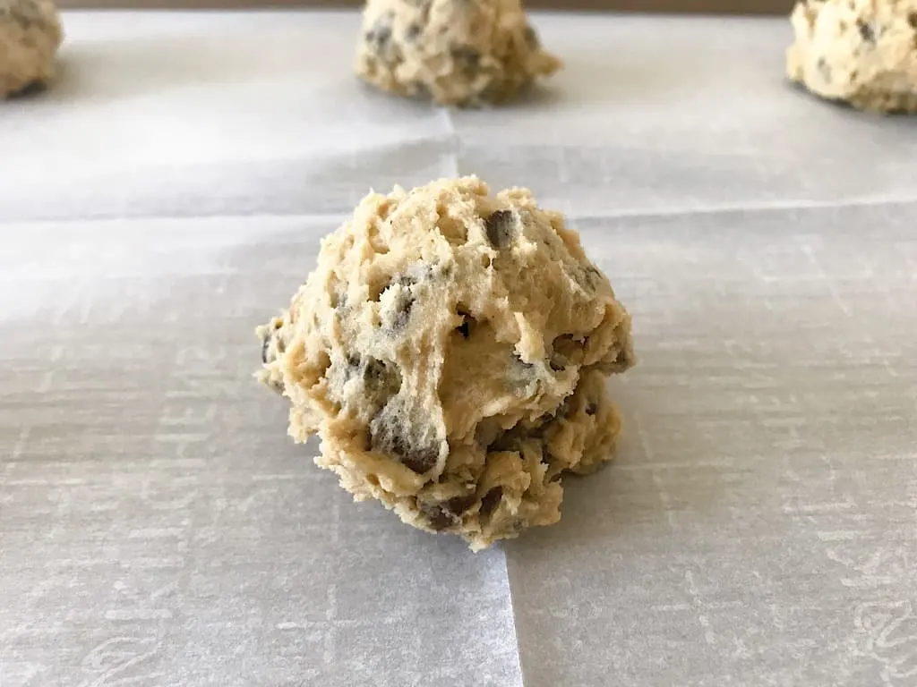 A ball of cookie dough on a baking sheet