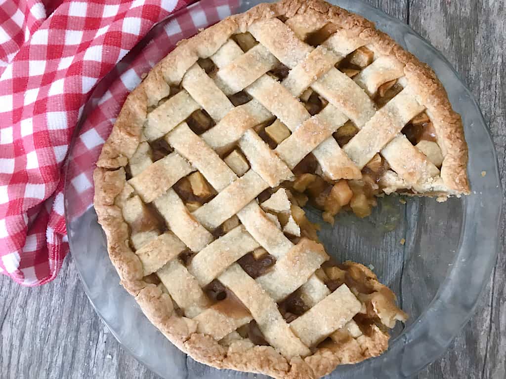 A slice taken out of an apple pie.