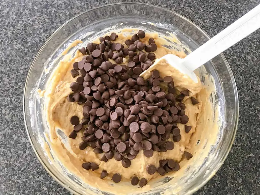 A bowl of peanut butter banana muffin batter with chocolate chips