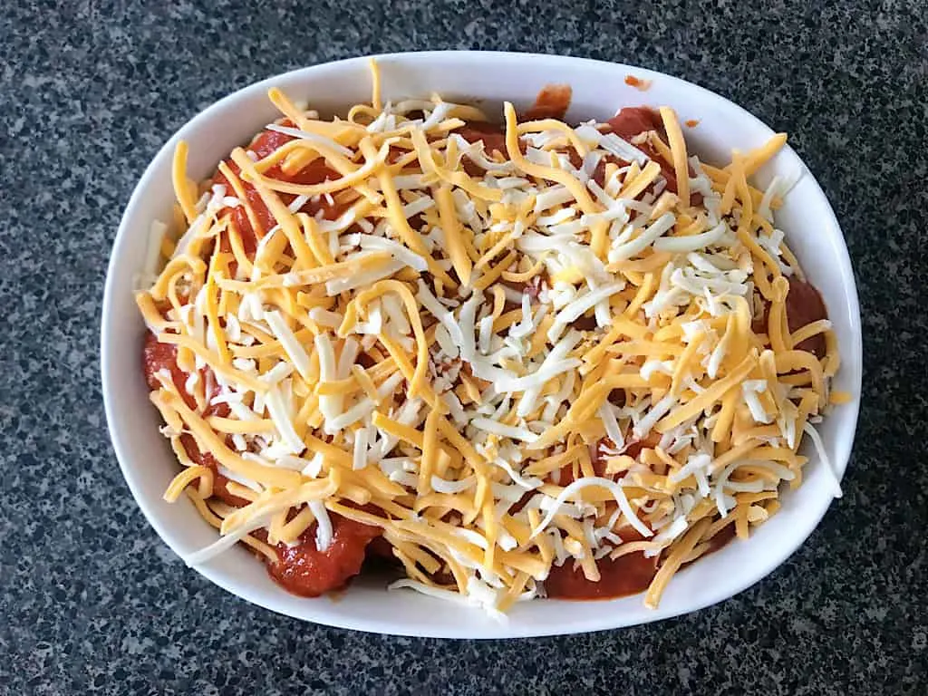 Layers of pasta, sauce, and cheese to make easy baked ravioli