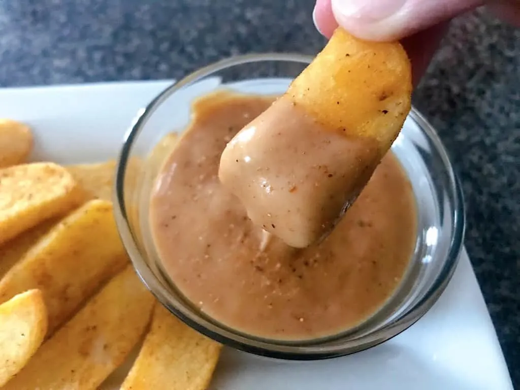 A French Fry dipped in Red Robin fry sauce