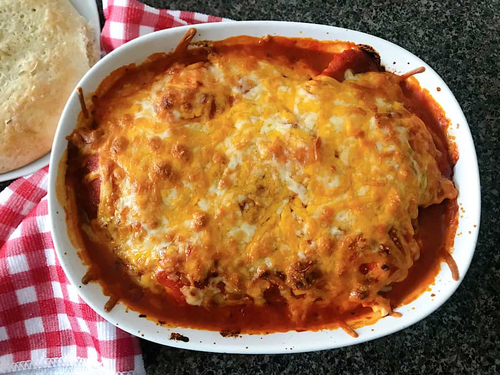 A baking dish of baked ravioli and bread