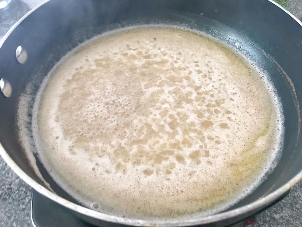 Water, butter, salt, and cinnamon for churros boiling