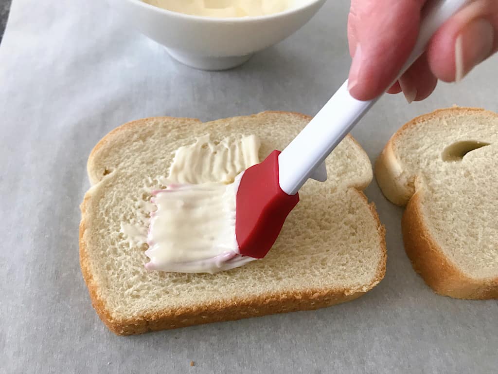 Mayonnaise spread on a piece of bread
