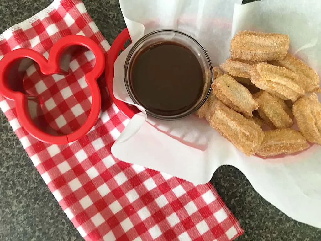 Mini Disney churros, chocolate sauce, and a Mickey Mouse cookie cutter