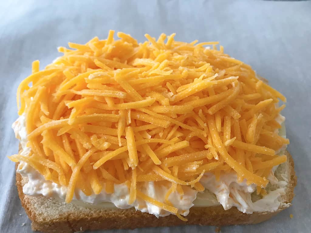 Cheddar on bread for a grilled cheese