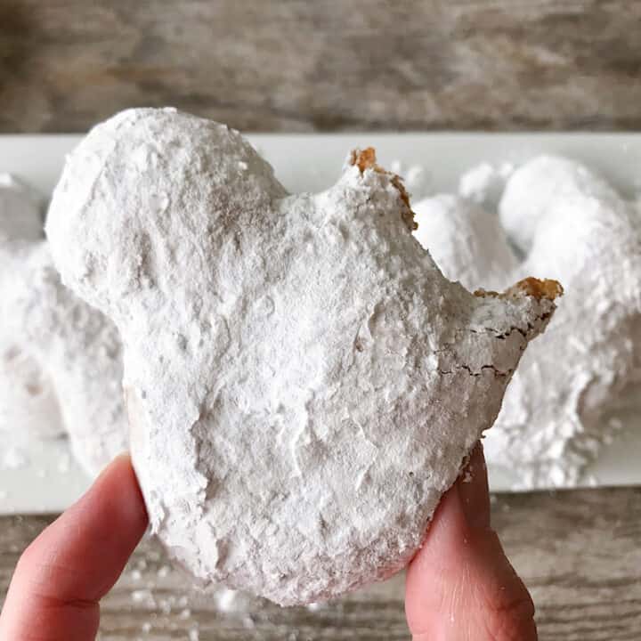 A Mickey Beignets made with pizza dough and covered in powdered sugar