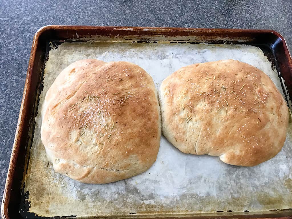 Sprinkle coarse salt over the tops of the bread and bake the loaves at 425 degrees for 18-25 minutes until the tops are golden brown.