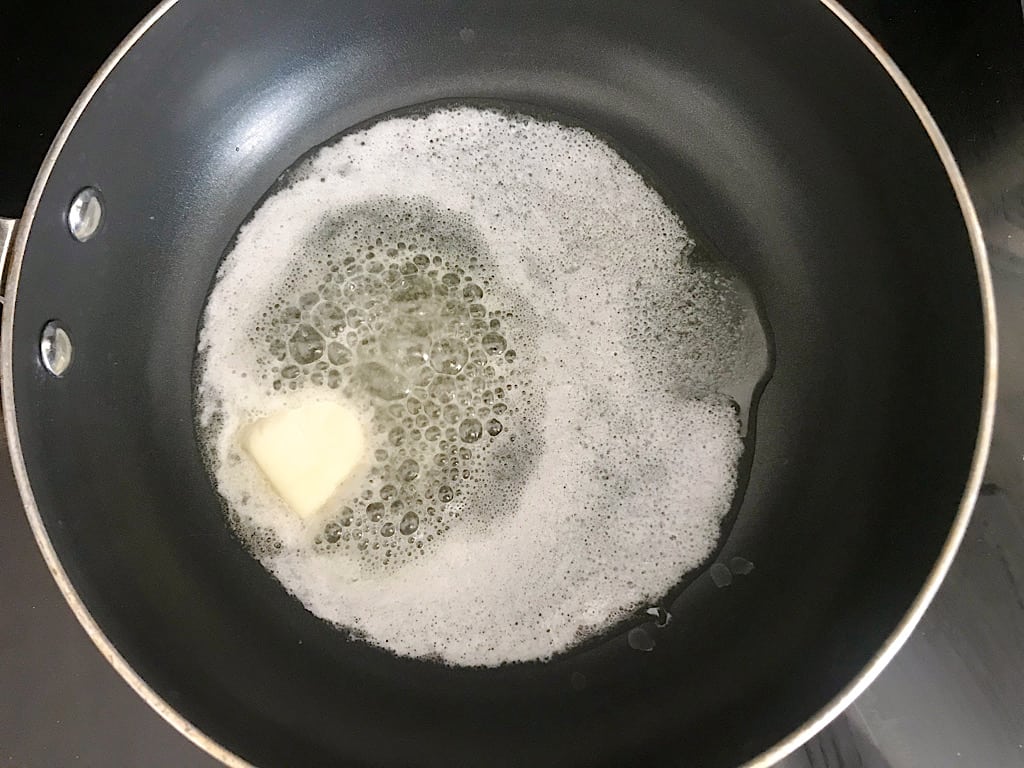 In a large sauce pan, melt the butter over medium-high heat.