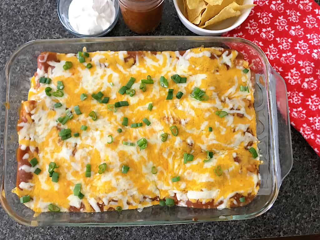 A pan of baked restaurant style cheese enchiladas